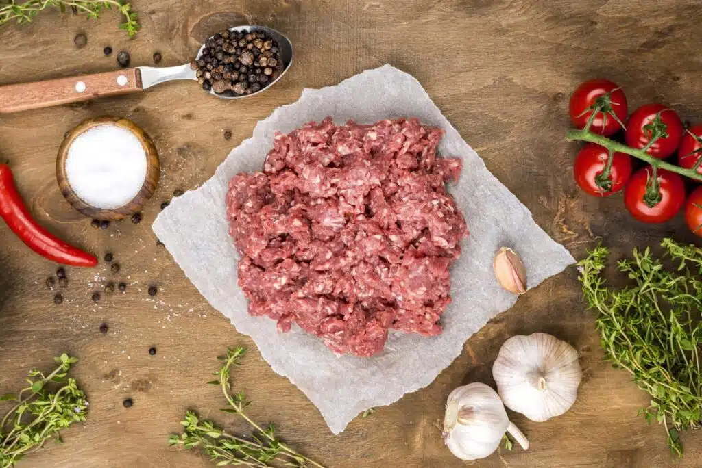 Healthy Ground Chicken Recipes: A vibrant presentation of healthy ground chicken recipes, including chicken lettuce wraps, tacos, meatballs with zoodles, and stuffed bell peppers, styled with fresh vegetables and garnishes