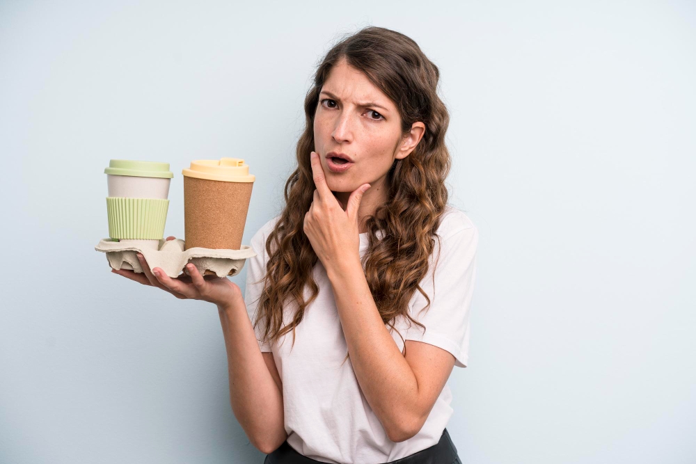 Person enjoying a healthy snack and coffee at a Starbucks table, focusing on mindful eating in a cozy cafe setting.